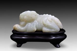 A Chinese Rare Jade Carving of a Mythical Lion from the Ming Dynasty (13th-16th Century). Stand is i