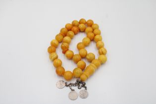 An Islamic Large Butterscotch Amber Prayer Beads with White Metal Tassel Weight: 188g with White