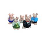 Five Wade Natwest pigs, comprising mother, father, daughter, son, and baby, each with stopper.