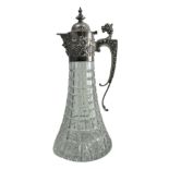 A 1970 silver and cut glass claret jug. Elaborate silver mount with mask head handle, Bacchanalian