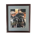 Arnold Schwarzenegger (b.1947) – A framed colour photograph signed by Arnold Schwarzenegger in