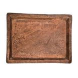 A Nigerian hammered copper serving tray from Kano, inter-crossing pattern on surface with KANO