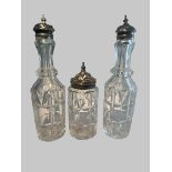 Three Victorian cut glass bottles with silver mounts, probably part of a cruet set. Birmingham