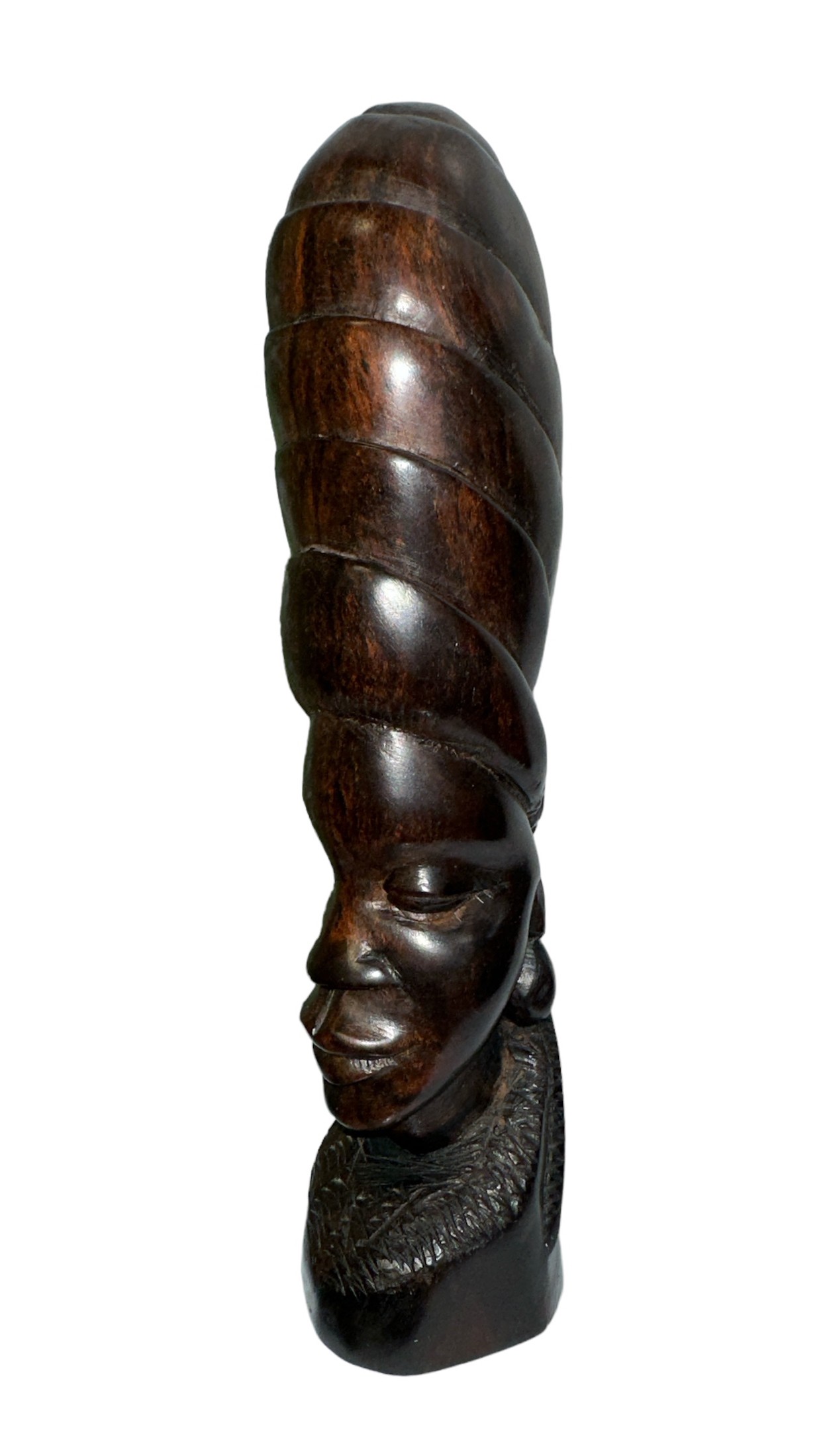 A standing African carved wooden sculpture in the shape of a woman’s head with a phallic design