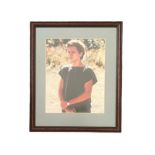 River Phoenix (1970-1993) – A framed colour photograph signed by River Phoenix in black ink “River