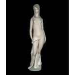 A large Lladro female nude bather figurine with matt glaze finish. Height 46.5cm.