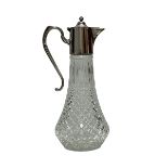 A glass claret jug with silver plated mount decorated with a beaded edge, approx 30cm high. Very