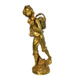 A polished brass sculpture of a walking boy with a bindle. Height 34cm.