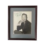 Bing Crosby (1903-1977) – A framed black and white photograph signed by Bing Crosby in green ink “To