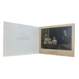 A 1954 Christmas card signed by HM Queen Elizabeth II. Gilt crown to cover, interior with a