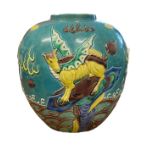 A large turquoise oriental ginger jar with raised decoration featuring two dragons and a winged