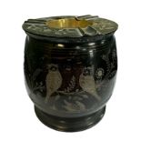 A black painted brass cigarette dispenser / ashtray with floral and bird design carved into the