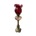A very good Victorian cast gilt brass Cranberry glass standing oil lamp, foliage design to base