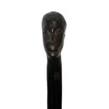An African carved hardwood twisted walking stick with carved head top. Height 83cm.