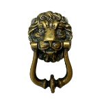 A brass lion head door knocker with twin bolt fixing.