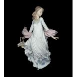 A large Lladro ‘Spring Splendor’ ceramic figurine of a lady holding a floral basket in a flowing