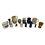 A selection of various interesting ceramic items to include; a Wade Harvest Ware “Cranky Tankard”