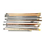 Collection of thirteen walking sticks, mostly with white metal tops, three have obscured hallmarks.