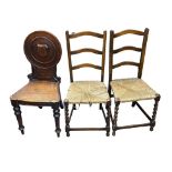 Victorian mahogany shield back hall chair plus two oak rush seat early 20th Century chairs.