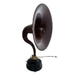 A large aluminium horn (gramophone style) shaped amplifying speaker brown/purple, circular base on