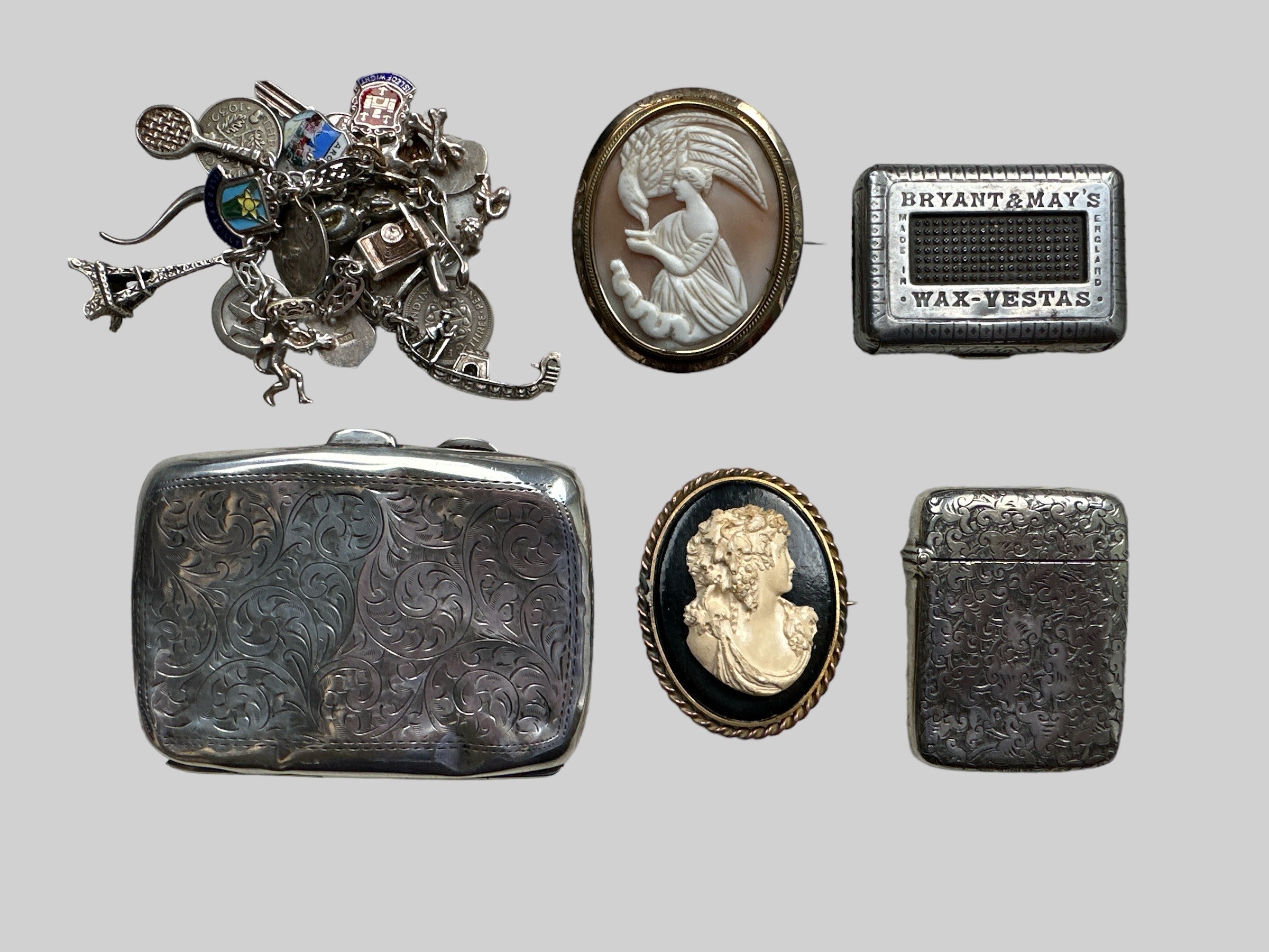 A range of items including a hallmarked silver card case (badly dented), a charm bracelet, 2 cameo