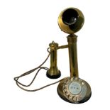 A 20th century vintage brass and candlestick telephone with chrome metal dial. Measures 32cm tall.