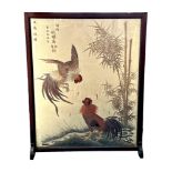 A Japanese silk fire screen in mahogany frame, featuring two chickens next to a river.