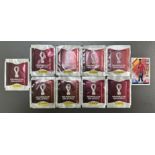 Nine unopened Qatar 2022 Panini football stickers and a Match Attax 101 The Road to UEFA Nations