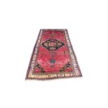Large Eastern (possibly Turkish) woven ground rug, stylised floral and geometric pattern with red