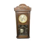 Early 20th Century Mahogany Cased Wall Clock. With pendulum and key. Height 77cm Width 32cm.