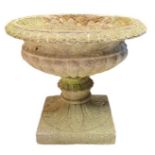 A concrete pedestal urn/planter