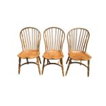 Three Ercol style hoop back dining chairs.