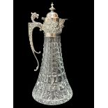 A 1970 silver and cut glass claret jug. Elaborate silver mount with mask head handle, Bacchanalian