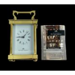 A brass cased carriage clock with bevelled glass panels, Matthew Norman, Swiss Made, complete with