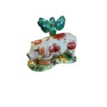 Staffordshire, a Staffordshire hand painted Pig figurine stood before a tree. Height 12cm.