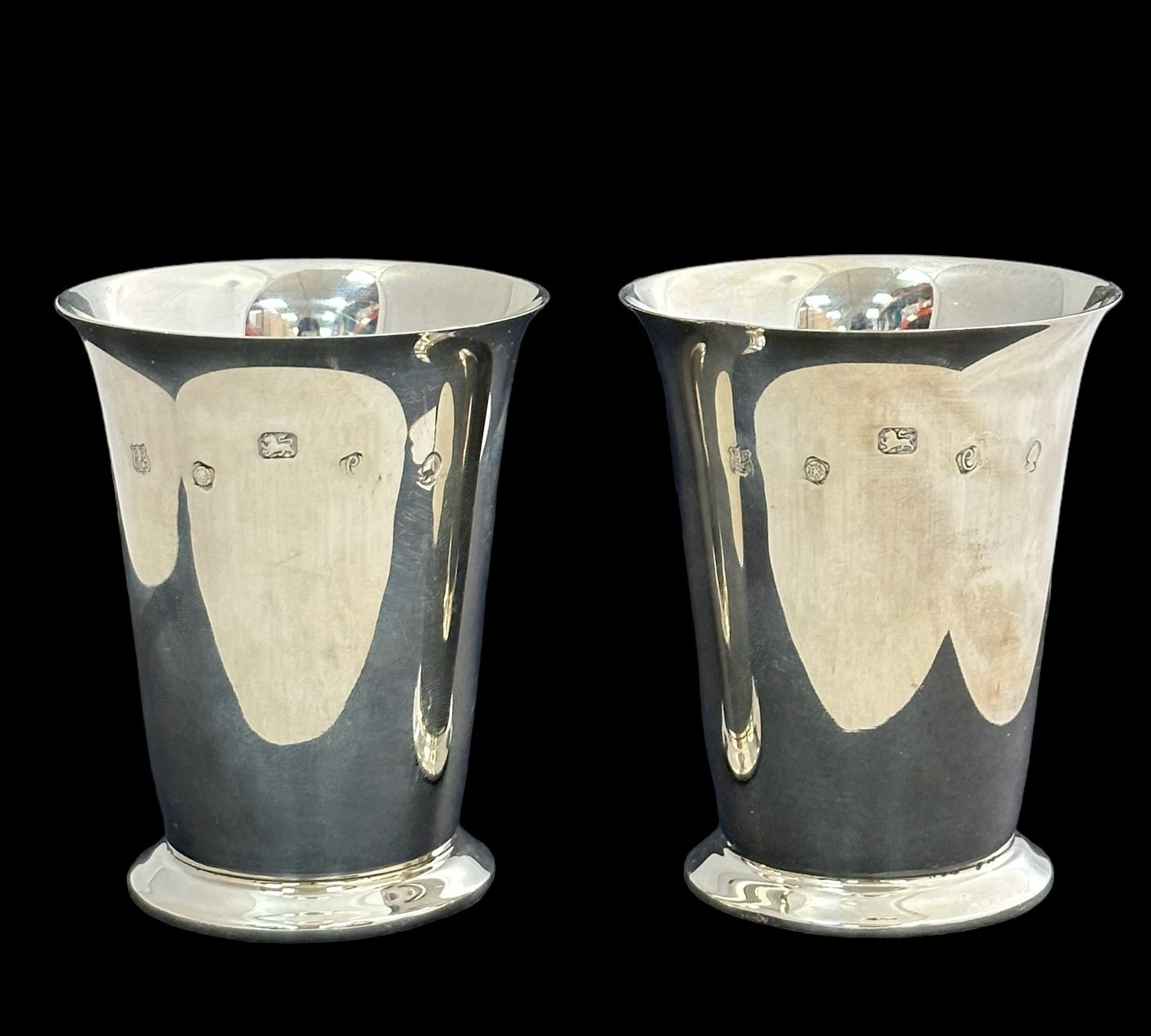 A silver pair of cups by Barker Ellis. 8cm in height. Fully hallmarked. Weight 151g in total.