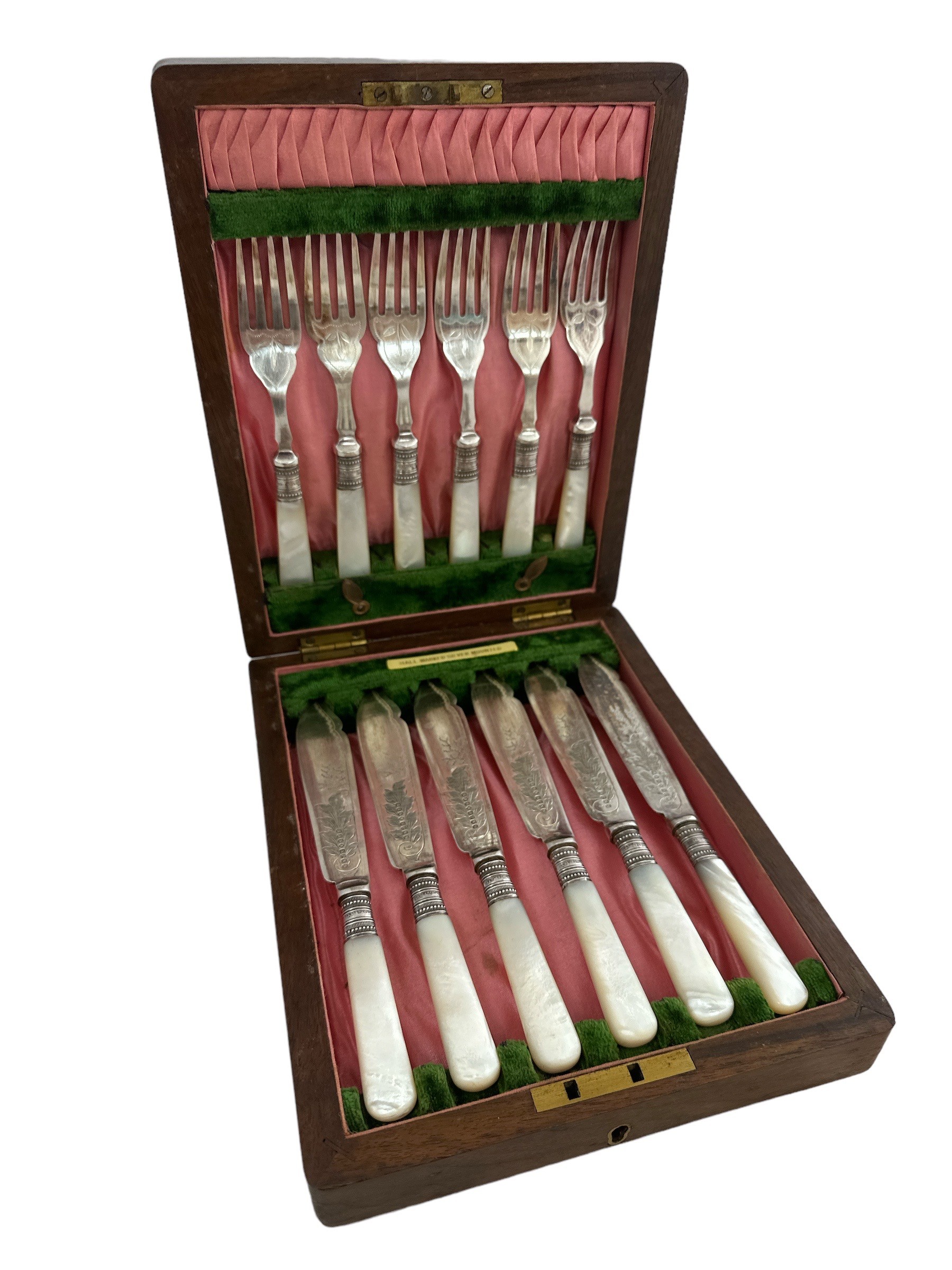 A cased set of 6 fish knives and forks with silver collars and mother of pearl handles. Made by J.