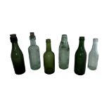 Selection of six various glass bottles to include; a Wood Brothers Daventry Codd Bottle with marble,