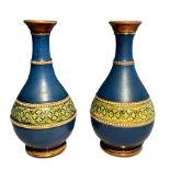 A pair of attractive small blue, green and gold vases with raised beaded decoration. Hairline