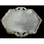 A large, unusually shaped and ornate white metal platter, possibly silver plate. Approx 58cm in