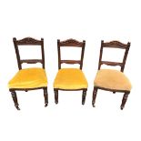 Three Edwardian carved chairs, casters to front legs (missing on one chair), height 94cm, width