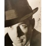 Humphrey Bogart (1899-1957) – A framed black and white photograph signed by Humphrey Bogart in black