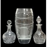 Two glass decanters, one approx 29cm in height, the other 24.5cm in height. And a large glass