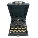 A German Remington Portable Typewriter in a black case.