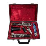 A Boosey & Hawkes 'Regent' ebonised section clarinet in plush lined hard case.