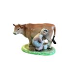 Ceramic milk maid milking cow figure (likely Staffordshire). Height 11.5cm, length 14cm.