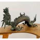 Japanese large bronze model of a dragon, the creature resting on three legs with its head and arm