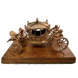 An extremely rare 9ct gold model of the Coronation Coach/ State Coach. Made in 1977 by Toye, Kenning