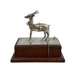 An attractive desk ornament with a white metal deer figure on wooden base.