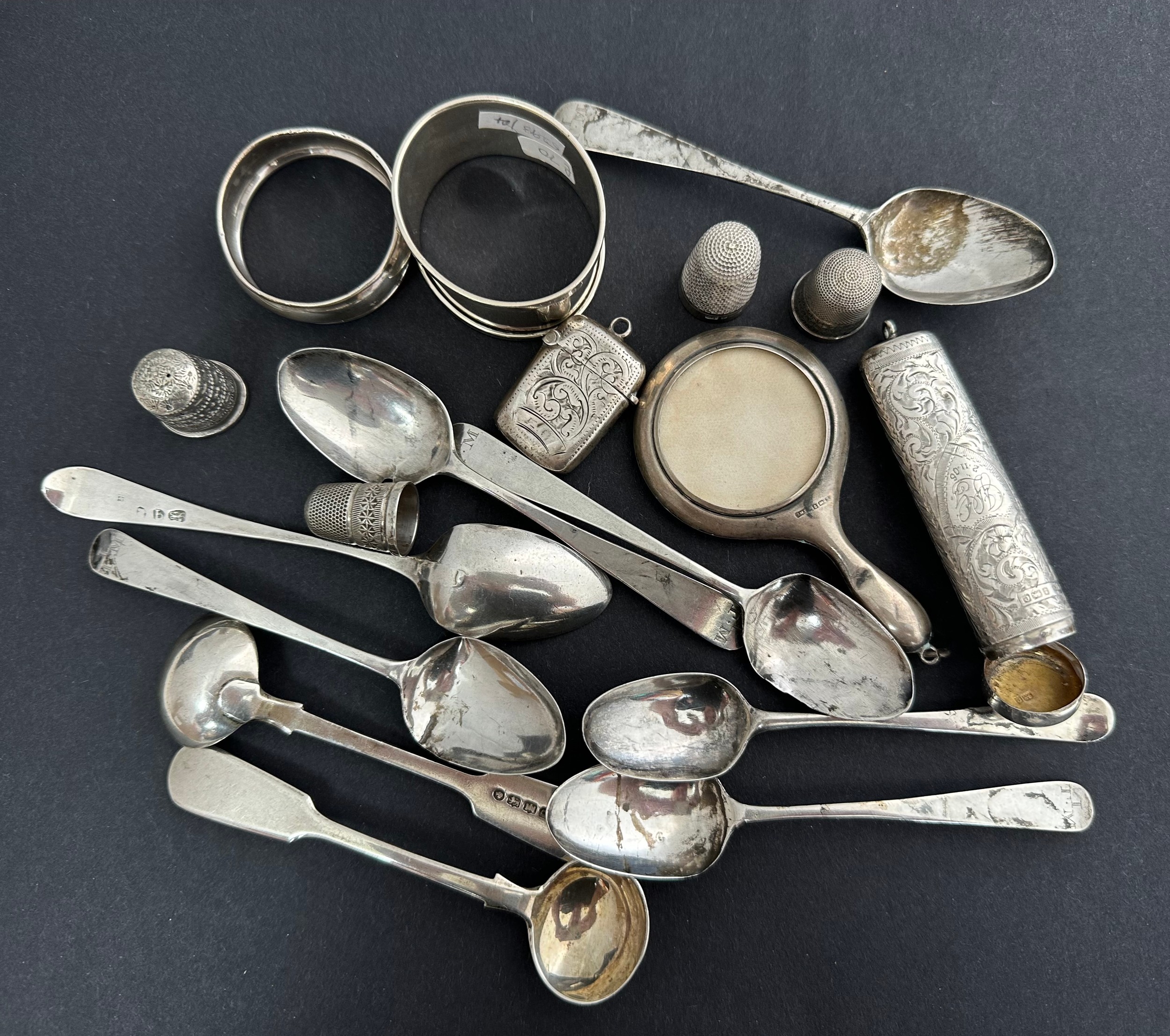 A range of sterling silver items including 2 napkin rings, one dented, 4 thimbles, vanity mirror,